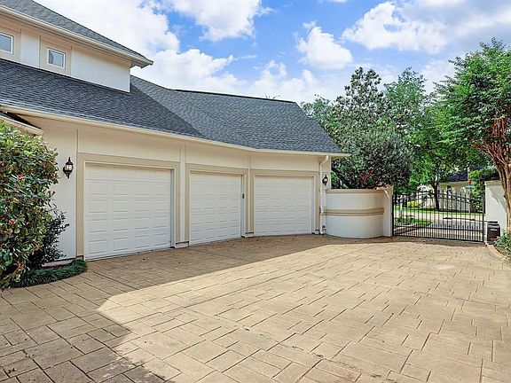 Three Car Garage with View of Auto Court and Gate. This is Being Viewed From the Back Yard