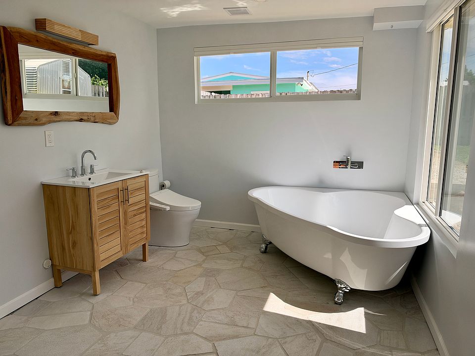 Suite bathroom; tub has handheld sprayer, no fixed shower head. Bidet toilet