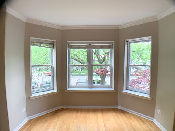 Living room 16-6 x 13-0 and large Bay Windows and hardwood flooring.