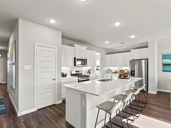 Kitchen in the Heisman home plan by Trophy Signature Homes - REPRESENTATIVE PHOTO