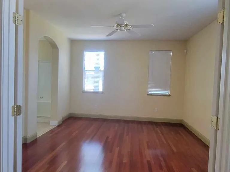 Master bedroom with double-doors, leads to private bathroom and walk-in closet