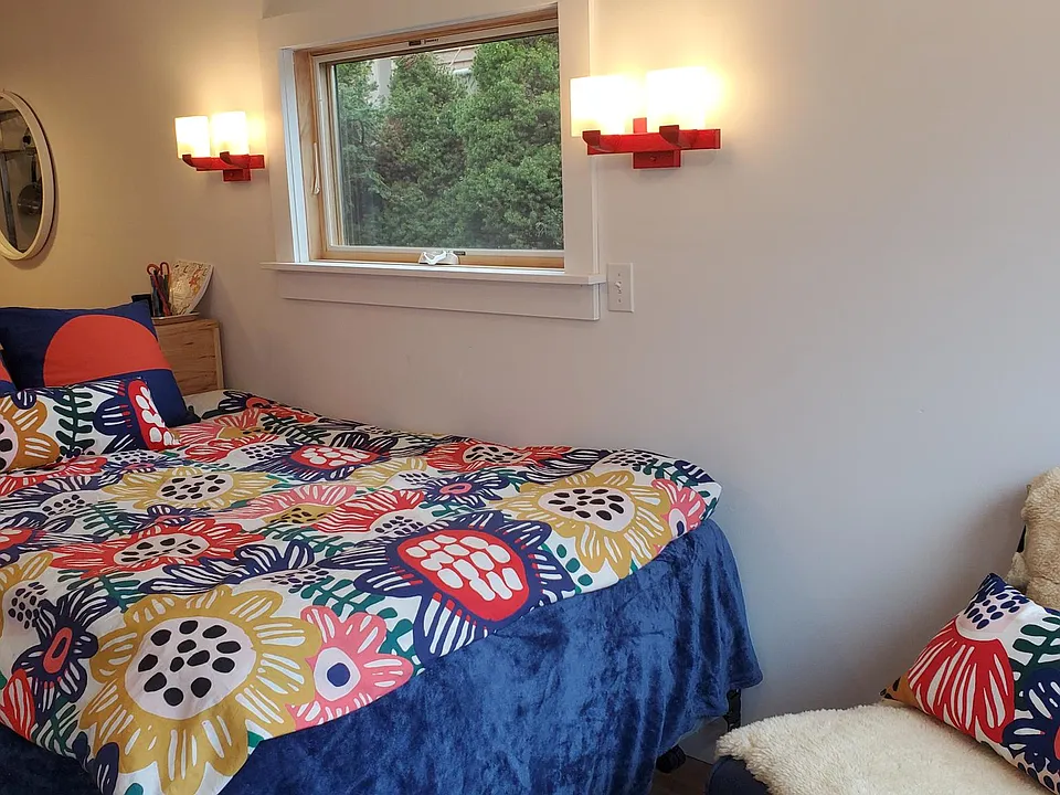The double bed has a custom headboard that doubles as a desk/eating counter.