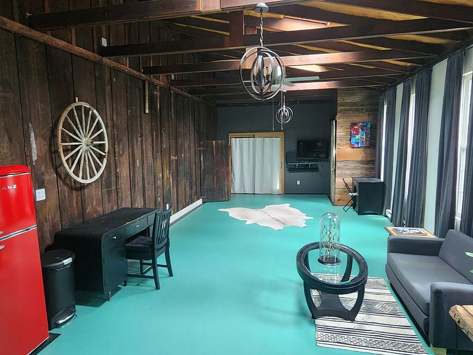 loft with partial view of kitchenette on left - 3 skylights
