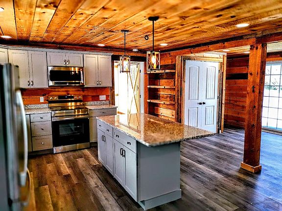 New eat-in kitchen with all stainless appliances and granite countertops. Overlooks private stone patio.