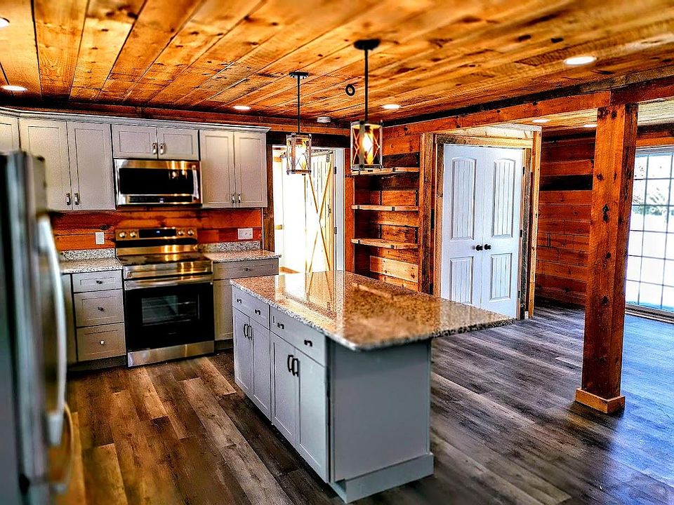 New eat-in kitchen with all stainless appliances and granite countertops. Overlooks private stone patio.