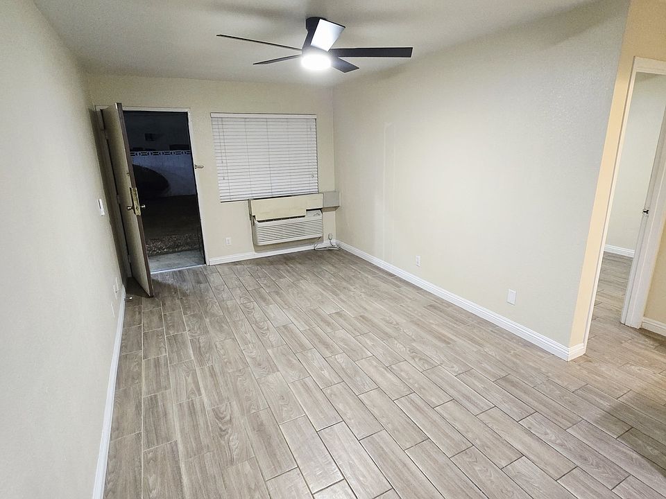 Living room with a brand new modern ceiling fan and tile flooring throughout