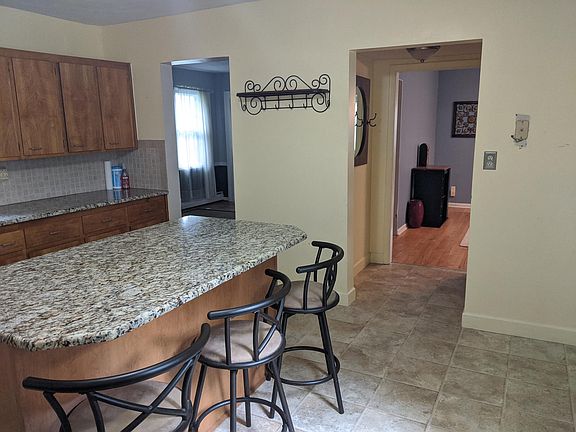 Kitchen leading into dining room and first living space