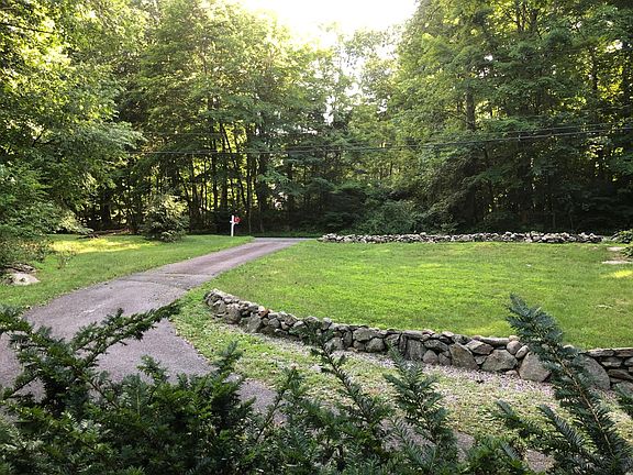 View towards street from living room-school bus stops at end of driveway