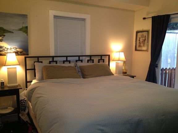 Bedroom 1 with French doors that walkout to private backyard.