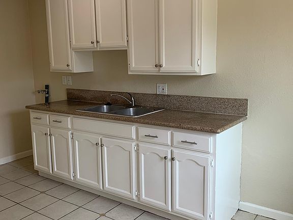 Granite countertop with washer hookup on the left (no dryer hookup)