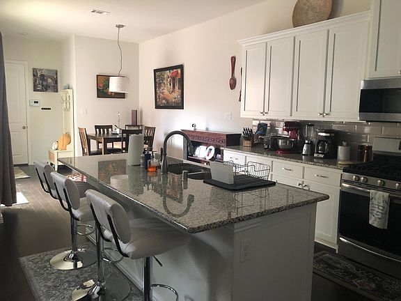Kitchen with plenty of storage, all appliances, hardwood flooring and granite countertops