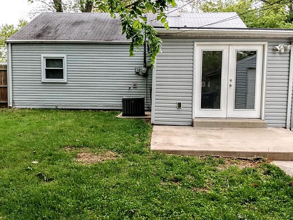 REAR OF HOME WITH CONCRETE PATIO