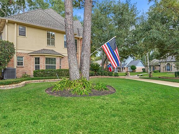 Side of the house looking onto Carlingwood Drive. The bay window from the dining room and extended brick landscape border enhance the detail of the home.