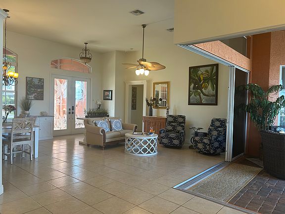 Front sitting area and opened 90 degree sliders out to lanai and pool