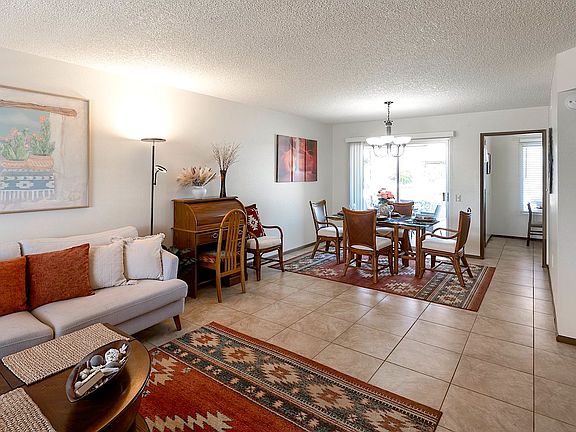 Solid wood coffee table includes lift-up eating trays.