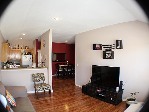 Wide angle view from windows towards kitchen and dining area