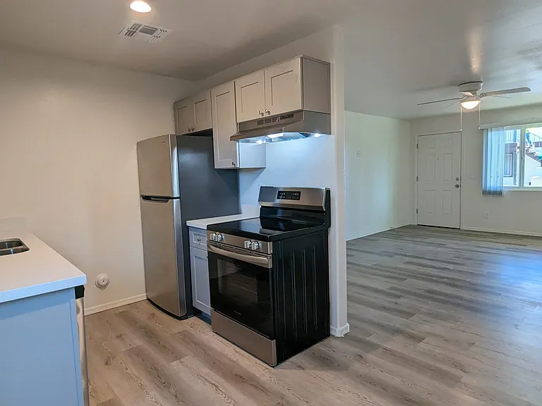 Remodeled kitchen with stainless steel appliances, dishwasher, range, fridge, and garbage disposal.
