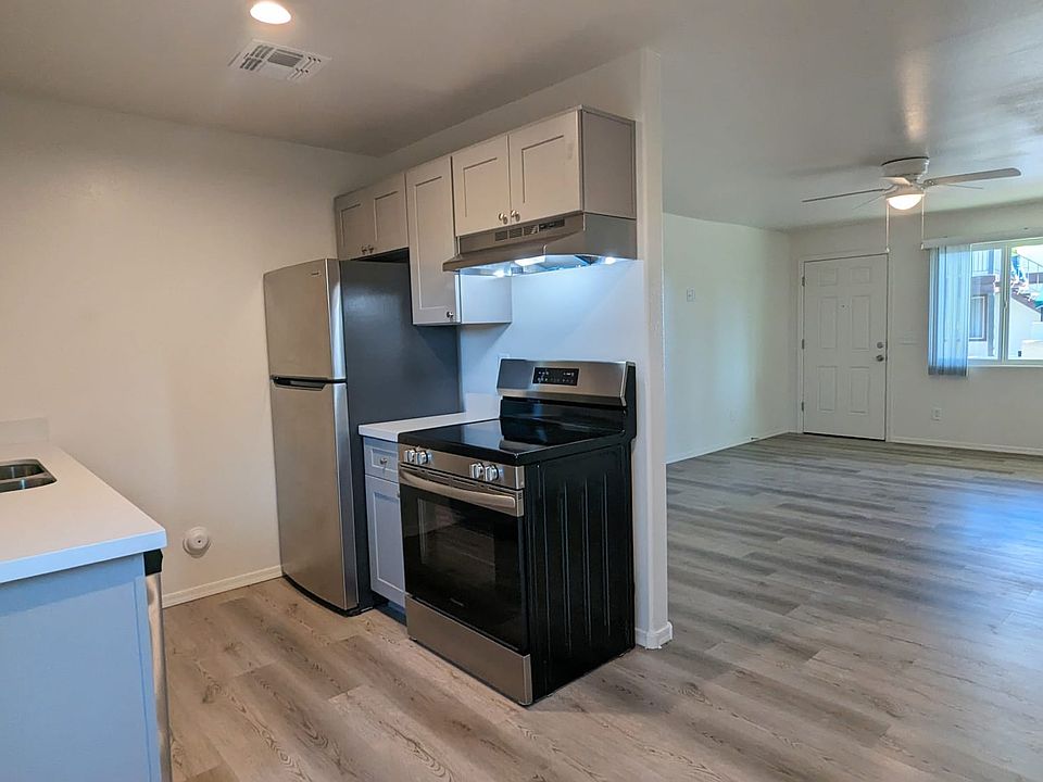 Remodeled kitchen with stainless steel appliances, dishwasher, range, fridge, and garbage disposal.