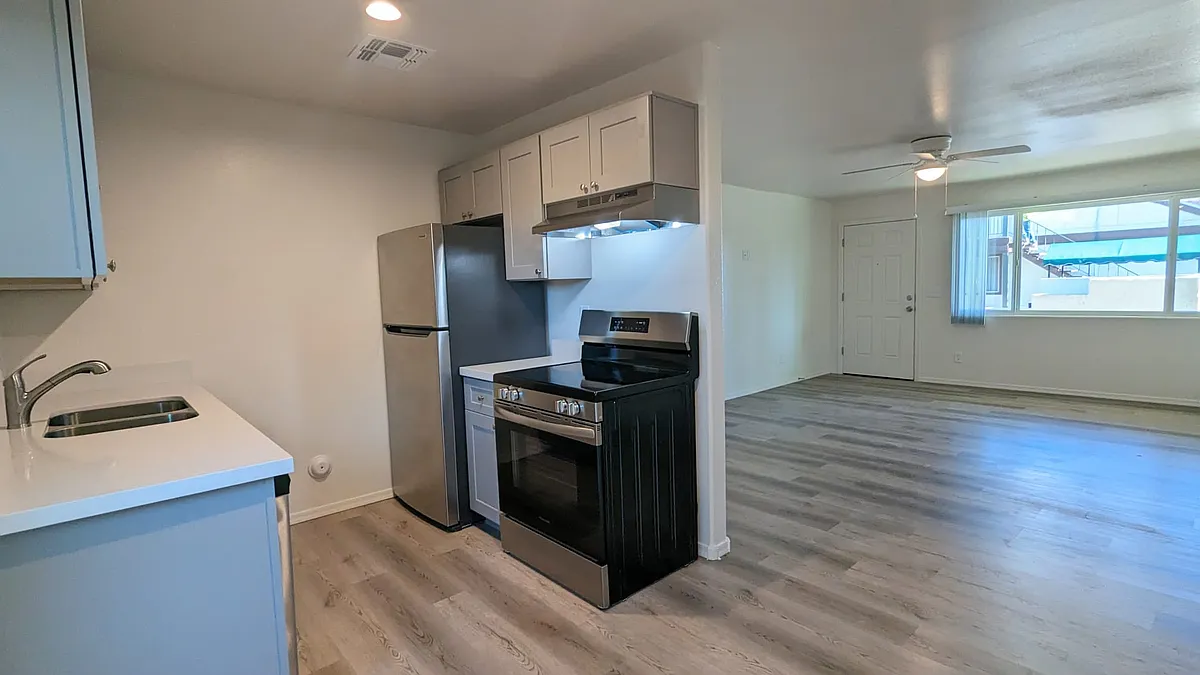 Remodeled kitchen with stainless steel appliances, dishwasher, range, fridge, and garbage disposal. - Village at Romero