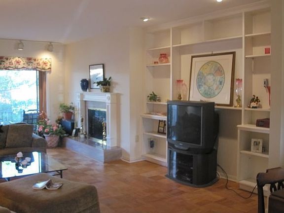 Living Room with Built-In Bookcases and Fireplace with Marble Surround/Hearth