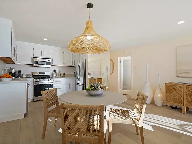 Gather around the dining table, where chic design meets the warmth of natural light.