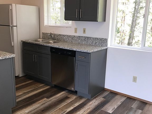 Dishwasher, full height shaker cabinetry.