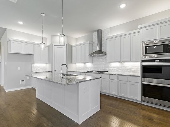 Kitchen in the Teton home plan by Trophy Signature Homes - REPRESENTATIVE PHOTO