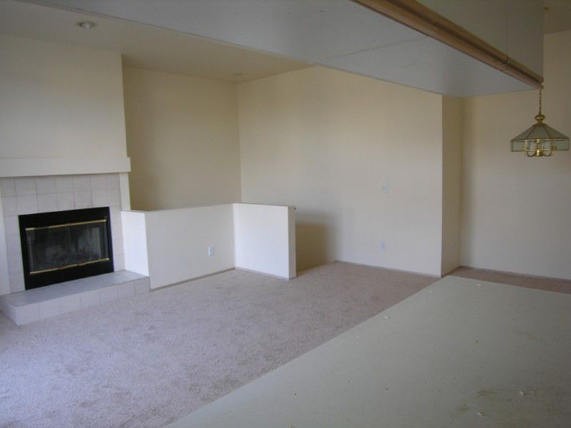 Living room with wood burning fireplace.