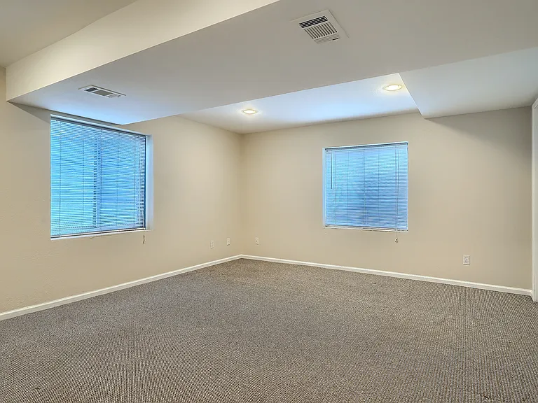 Basement rec room with egress windows (often used as a bedroom)