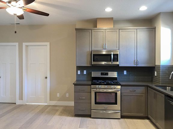 Kitchen and doors to guest bath and 2nd bedroom.