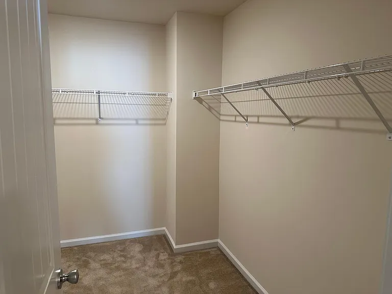 A view into the main bedroom walk in closet