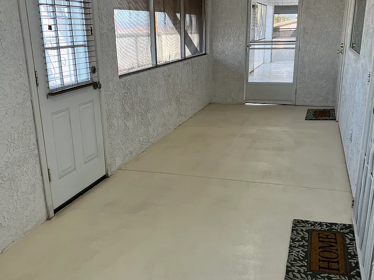 Arizona room attached to 3 bedroom side of the home (looking towards Arizona room attached to one bedroom side of home) & door to outside patio