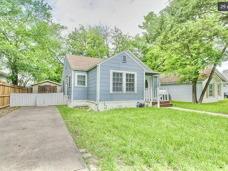 Dedicated driveway parking space, additional side entrance behind fence.