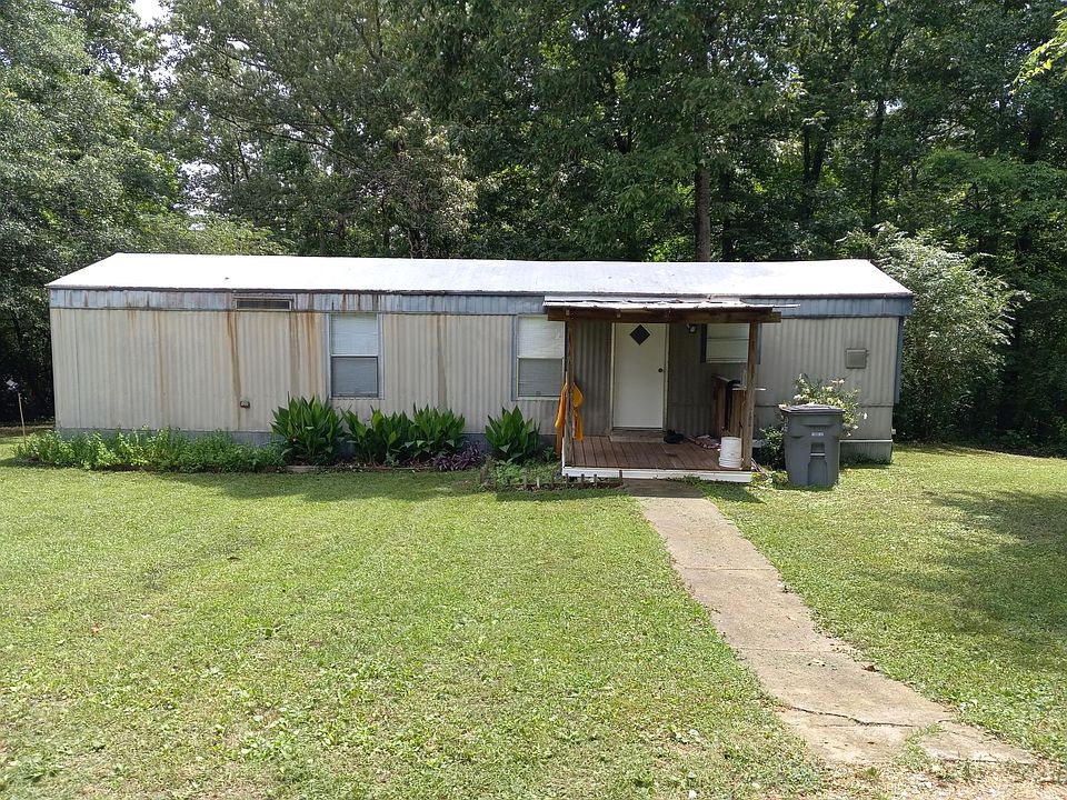 front of the home; windows left to right are: small bedroom, living room, kitchen