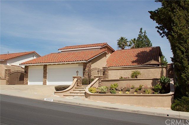 Fabulous curb appeal with a tiered succulent garden, stacked stone details, flagstone accents and mo