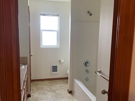 Full bathroom with double sinks and linen closet