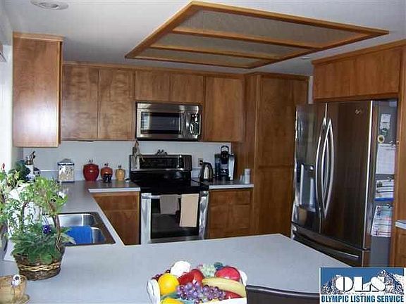 The kitchen features stainless appliances purchased within the last and one half. The breakfast bar is a great place to read, plan menus or - take a meal or cup of coffee. 