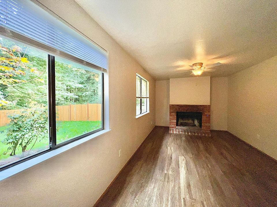 Family room with fireplace and view of private backyard
