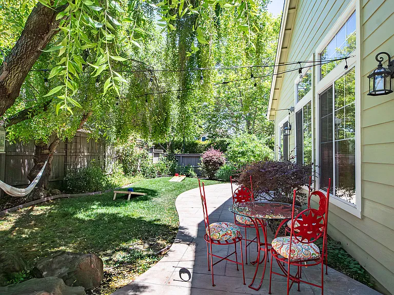 Backyard with hammock, table and chairs.
