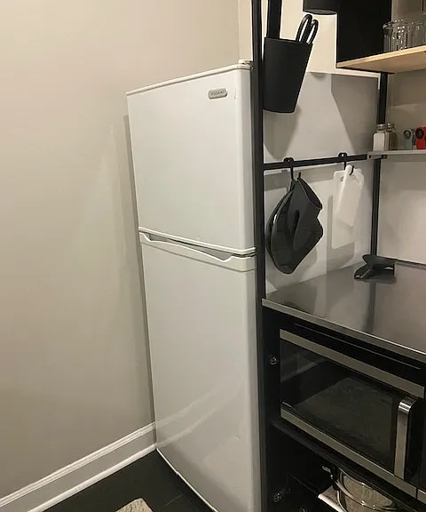 Apartment size freezer and refrigerator offering plenty of space for your perishable and frozen foods.