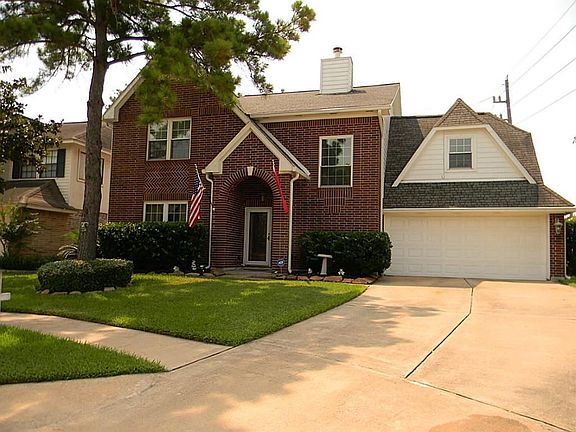 Side view with attached 2 car garage. Whole house has been updated with double pane windows.