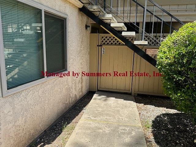Front of unit, entrance behind gated patio
