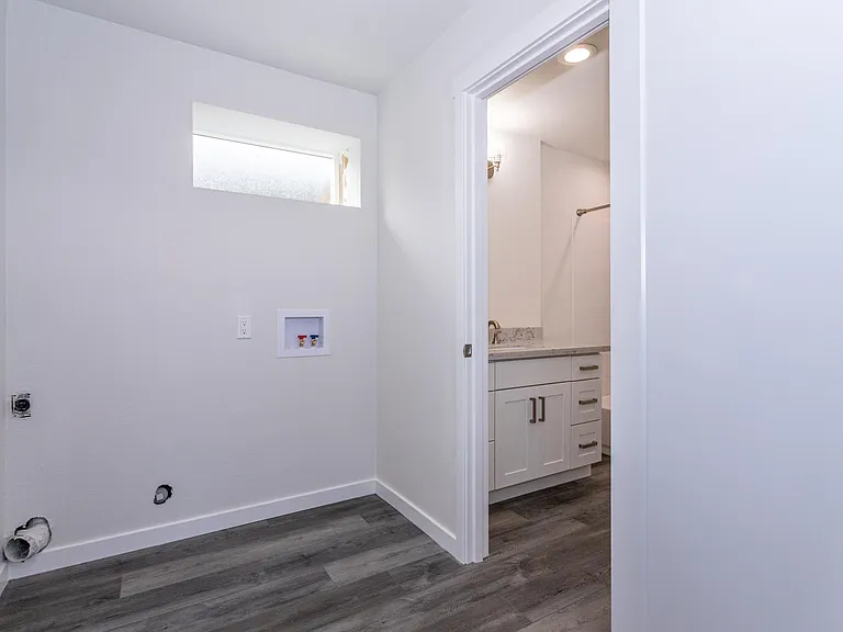 Utility room and 3rd bathroom downstairs. Washer & dryer to be installed prior to occupancy.