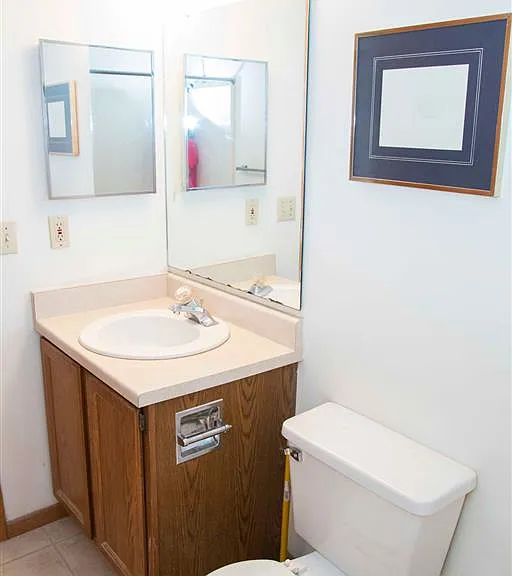 Simple and efficientthis bathroom features a large mirror, storage vanity, and all the essentials to start your day right.