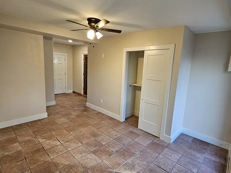 Large Living space or possible 3rd bedroom with door out to carport