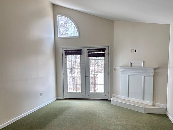 vaulted ceiling living area looking out towards private deck