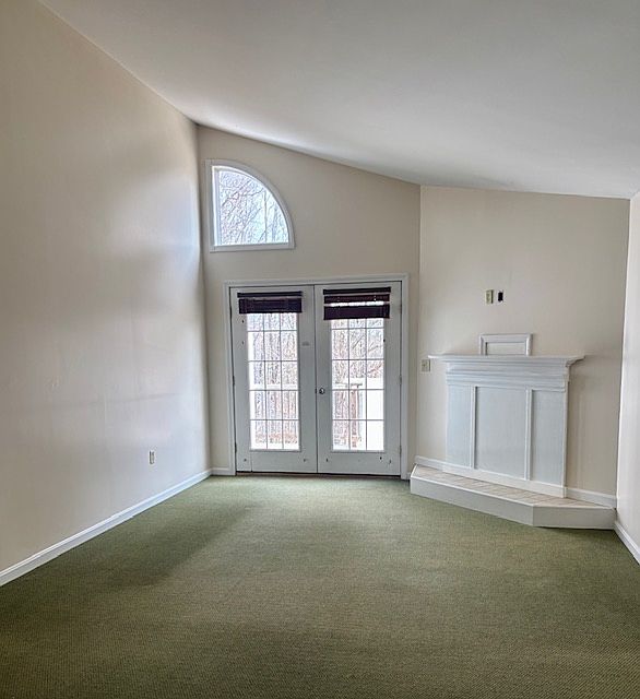 vaulted ceiling living area looking out towards private deck