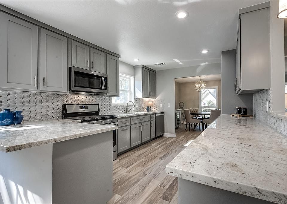 This stunning kitchen is completely remodeled with custom cabinets, beautiful granite countertops and brand new stainless steel appliances.