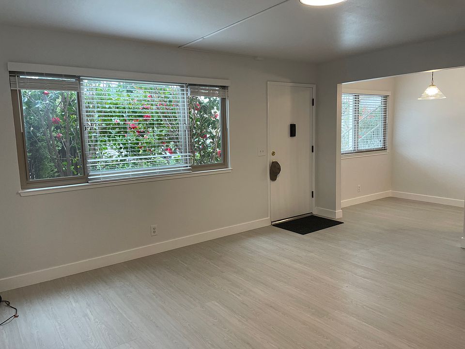Living room (large windows looking out through Camelia bush).
Opens to Eating Area (right side of entry door) New Laminate flooring continuous with Kitchen