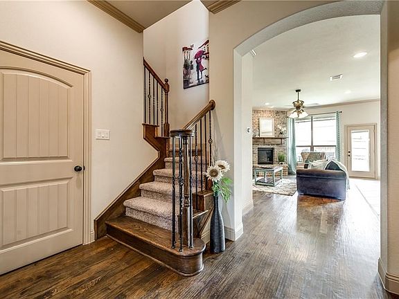 As you enter you are welcomed in with the staircase and a view into the bright, open family room!